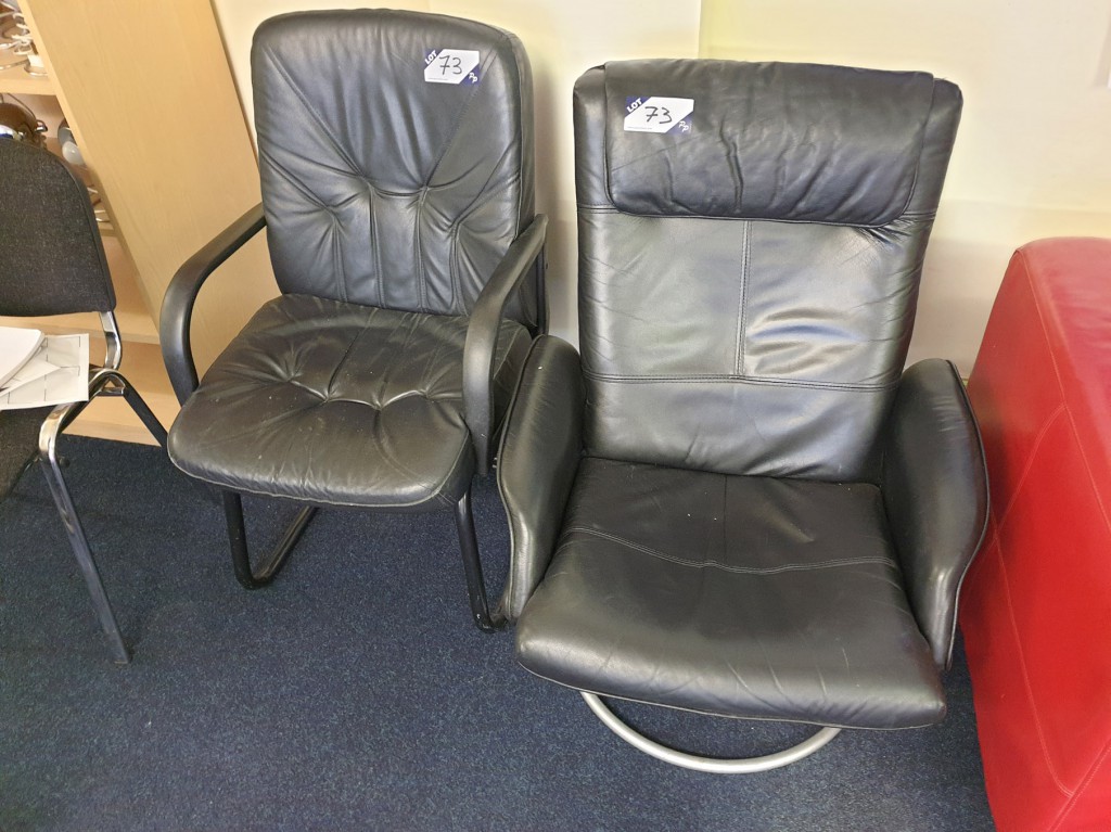 2x black leather effect chairs