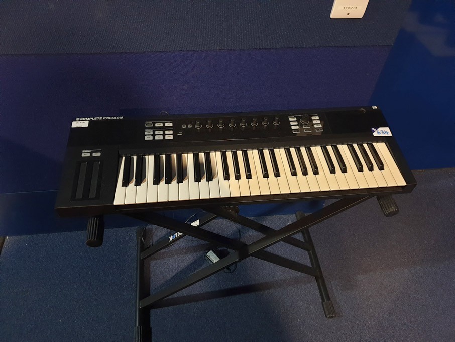 Komplete Kontrol S49 electronic keyboard on stand