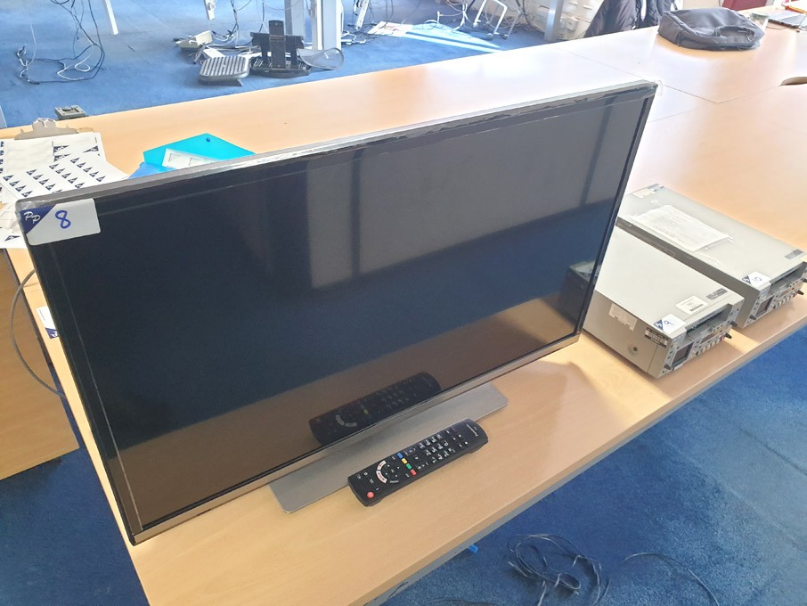 Panasonic TX-32GS352B TV on stand with remote