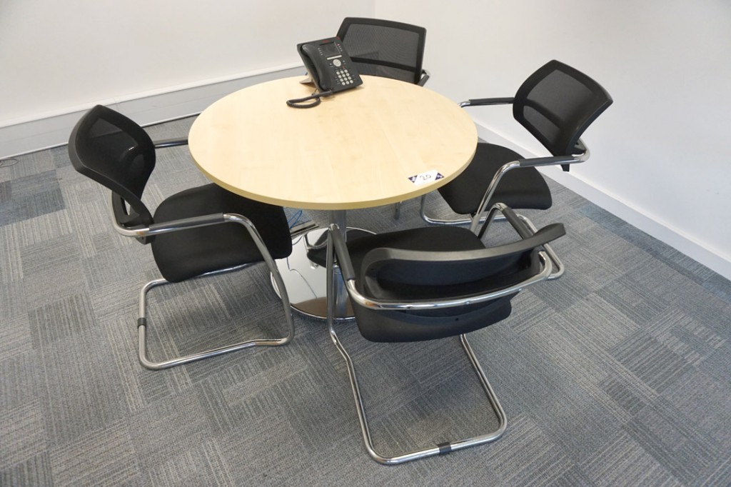 Maple 1000mm dia office table with 4x black uphols...