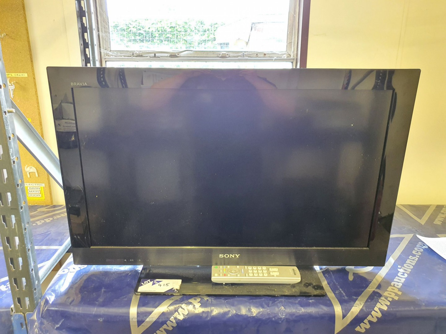 Sony KDL-32CX523 LCD TV on stand with remote