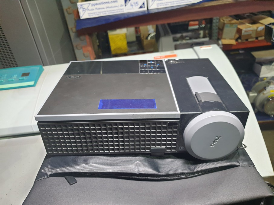 Dell 1409x projector in padded bag - lot located a...