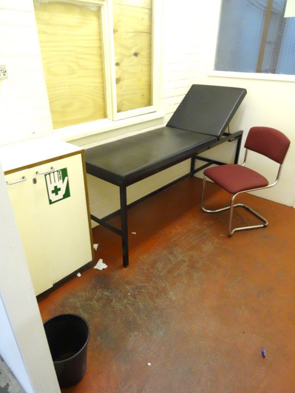 Contents of First Aid room inc: 2 door wooden cupb...